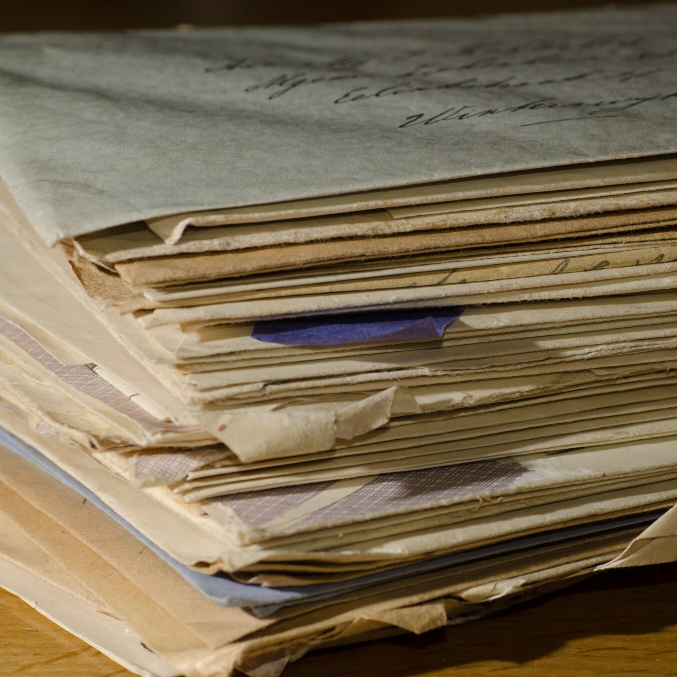 a stack of handwritten letters in envelopes